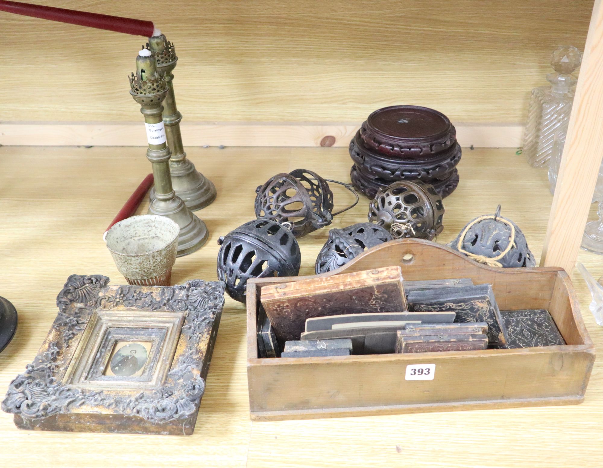 A group of mixed collectables including five pomanders, a pair of brass candlesticks, Oriental stands and a quantity of daguerreotypes